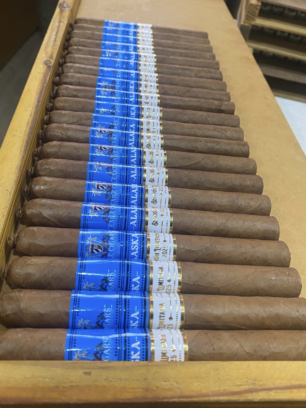 Rows of hand-rolled Exile Cigars Alaska cigars laid out on the factory rolling table at La Union Factory